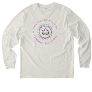 Off-white long-sleeve t-shirt with a purple and green circular logo on the chest that reads East Troy Acupuncture, Empowered Patient Press.